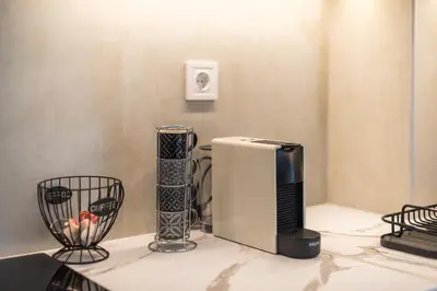 a kitchen counter with a refrigerator and other appliances at Elena's house in Athens