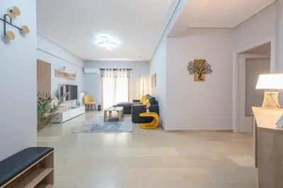 a living room with a couch and a table at Elena's house in Athens