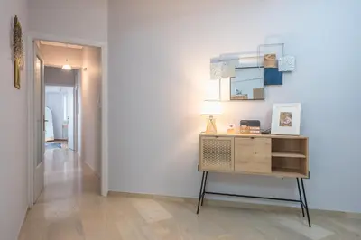 a hallway with a dresser and a mirror on a wall at Elena's house in Athens
