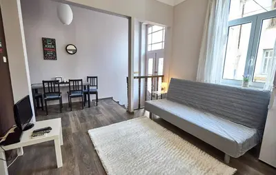 a living room with a couch and a table at Retro Elegant in Athens