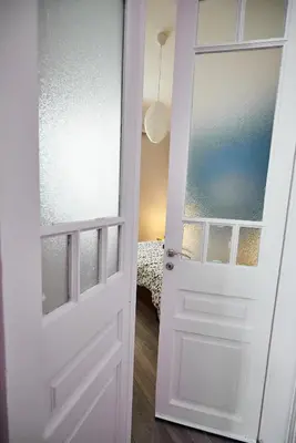 a white door in a room with a bed at Retro Elegant in Athens