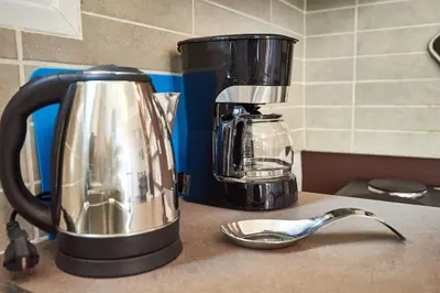 a coffee maker sitting on a counter next to a coffee pot at Retro Elegant in Athens