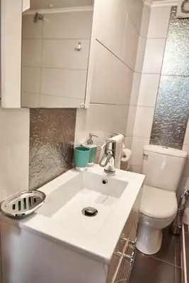 a bathroom with a white sink and a toilet at Retro Elegant in Athens