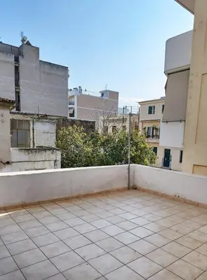 an empty balcony in a city with buildings at Retro Elegant in Athens