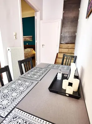 a dining table with two chairs and a tray with candles at Retro Elegant in Athens