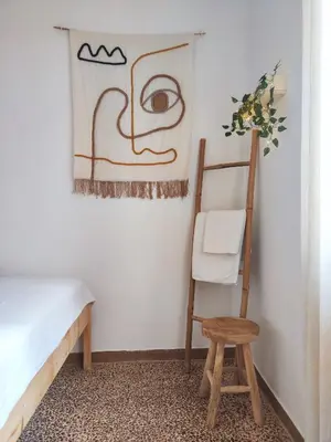 a room with a chair and a painting on the wall at Casa Lula in Athens