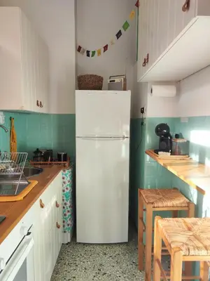 a kitchen with a white refrigerator in a room at Casa Lula in Athens