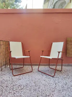 two chairs sitting next to each other against a wall at Casa Lula in Athens
