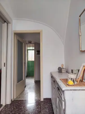 a kitchen with white walls and an archway at Casa Lula in Athens