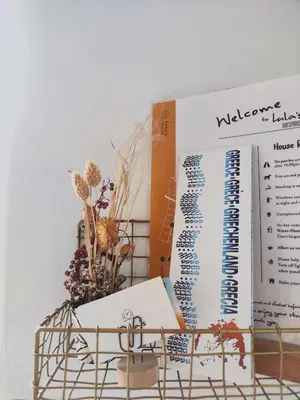 a table with a book and a bird cage at Casa Lula in Athens