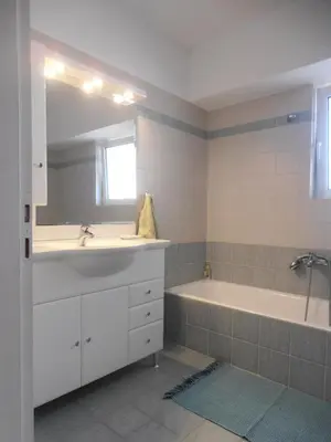 a bathroom with a sink and a bath tub at Peaceful Hilltop View Maisonette in Anavissos