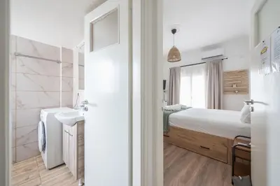 a bathroom with a bed and a sink in a room at Ble Elia Flat for two in Athens in Athens
