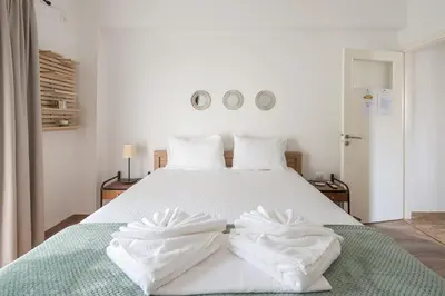 a bedroom with a bed with towels on it at Ble Elia Flat for two in Athens in Athens