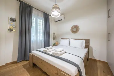 a bedroom with a large bed with towels on it at Ble Elia Artemis Suite in Athens