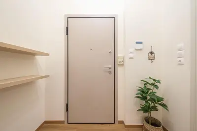 a door in a room with a potted plant at Ble Elia Artemis Suite in Athens