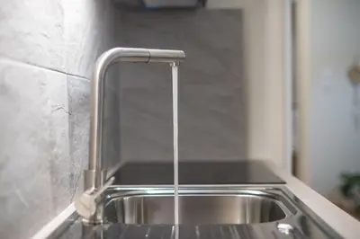 a stainless steel sink with a faucet at Ble Elia Artemis Suite in Athens