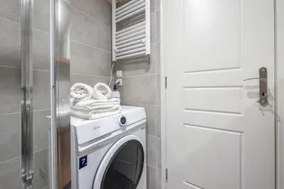 a washer and dryer in a small bathroom at Ble Elia Artemis Suite in Athens