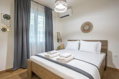a bedroom with a large bed with towels on it at Ble Elia Artemis Suite in Athens