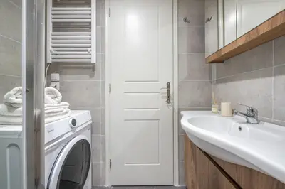 a bathroom with a washing machine and a sink at Ble Elia Artemis Suite in Athens