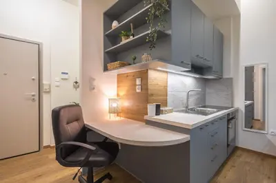 a kitchen with a desk with a chair and a sink at Ble Elia Artemis Suite in Athens