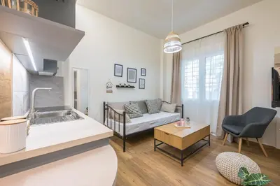 a living room with a couch and a table at Ble Elia Artemis Suite in Athens