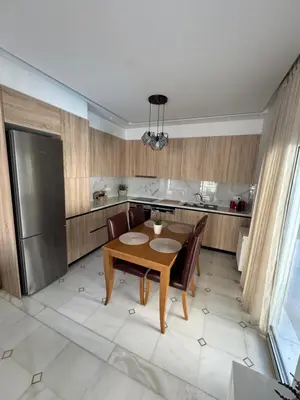 a kitchen with a table and chairs and a refrigerator at Caza pool Glyfada in Athens