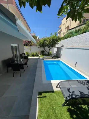 a swimming pool in the backyard of a house at Caza pool Glyfada in Athens
