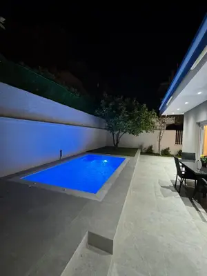 a swimming pool in a backyard at night at Caza pool Glyfada in Athens