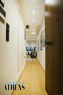 a hallway with a door leading to a living room at Eugene's Deluxe Athenian apt 4ppl 5 min wd Metro in Athens