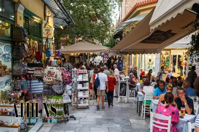 a crowd of people walking through a market with shops at Eugene's Deluxe Athenian apt 4ppl 5 min wd Metro in Athens