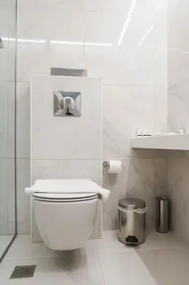 a white bathroom with a toilet and a sink at Athens Cypria Hotel in Athens