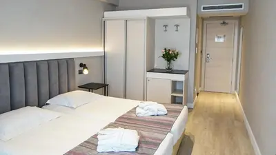 a bedroom with a bed with two white pillows at Athens Cypria Hotel in Athens