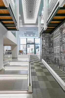 an empty lobby with a mural of buildings on the wall at Athens Cypria Hotel in Athens