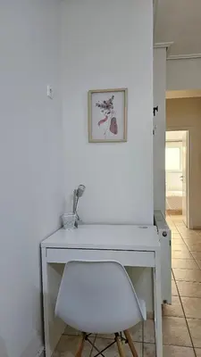 a white desk with a chair and a picture on the wall at Casa Geli l Comfort meets charm, centrally located in Athens