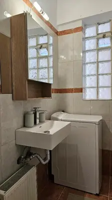 a bathroom with a sink and a toilet and a window at Casa Geli l Comfort meets charm, centrally located in Athens