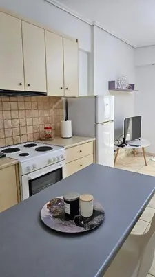 a kitchen with a table with two cups on it at Casa Geli l Comfort meets charm, centrally located in Athens