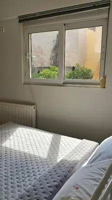 a bedroom with a bed and a window at Casa Geli l Comfort meets charm, centrally located in Athens