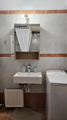 a bathroom with a sink and a washing machine at Casa Geli l Comfort meets charm, centrally located in Athens