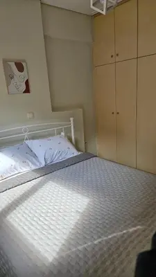 a bedroom with a bed with a white mattress at Casa Geli l Comfort meets charm, centrally located in Athens