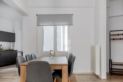 a dining room with a table and chairs at Arco - Sleek 2-BR Apt in the Heart of Athens in Athens