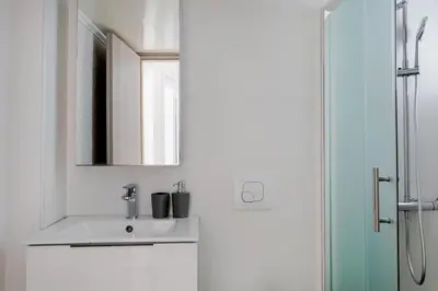 a bathroom with a sink and a mirror at Arco - Sleek 2-BR Apt in the Heart of Athens in Athens