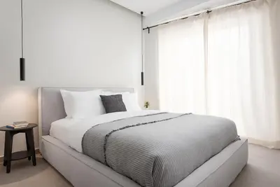 a white bedroom with a large bed and a window at Athens Luxury Ethereal View in Athens
