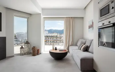 a living room with a couch and a large window at Athens Luxury Ethereal View in Athens
