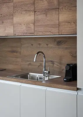 a stainless steel sink in a kitchen with wooden cabinets at Athens Luxury Ethereal View in Athens