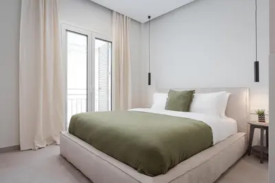 a white bedroom with a large bed and a window at Athens Luxury Ethereal View in Athens