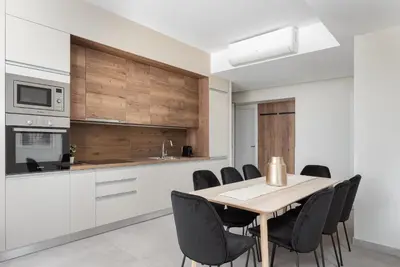 a kitchen with a wooden table and black chairs at Athens Luxury Ethereal View in Athens