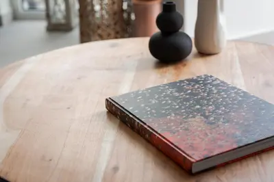 a book sitting on top of a wooden table at Athens Luxury Ethereal View in Athens