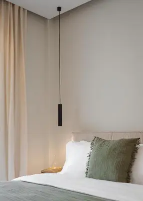 a bedroom with a white bed with a green pillow at Athens Luxury Ethereal View in Athens