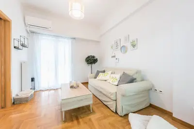 a living room with a couch and a table at Ble Elia Acropolis 2bdr Suite in Athens