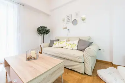 a living room with a couch and a table at Ble Elia Acropolis 2bdr Suite in Athens